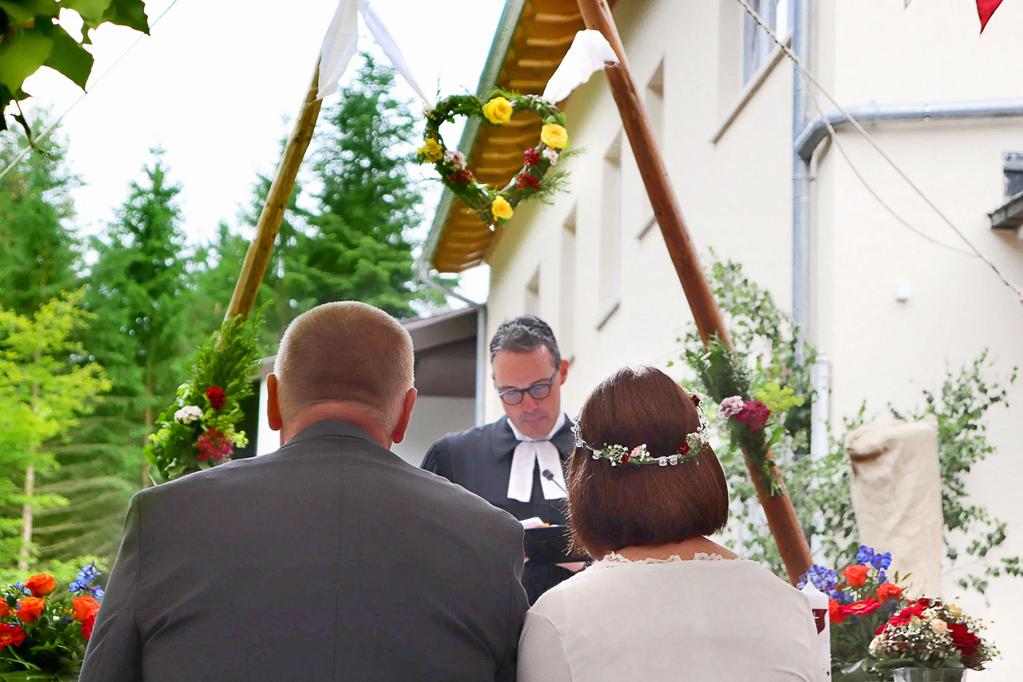 Quelle: Familie Lückhof-Stuckmann | privat Brautpaar sitzt vor dem Pfarrer während der Trauzeremonie