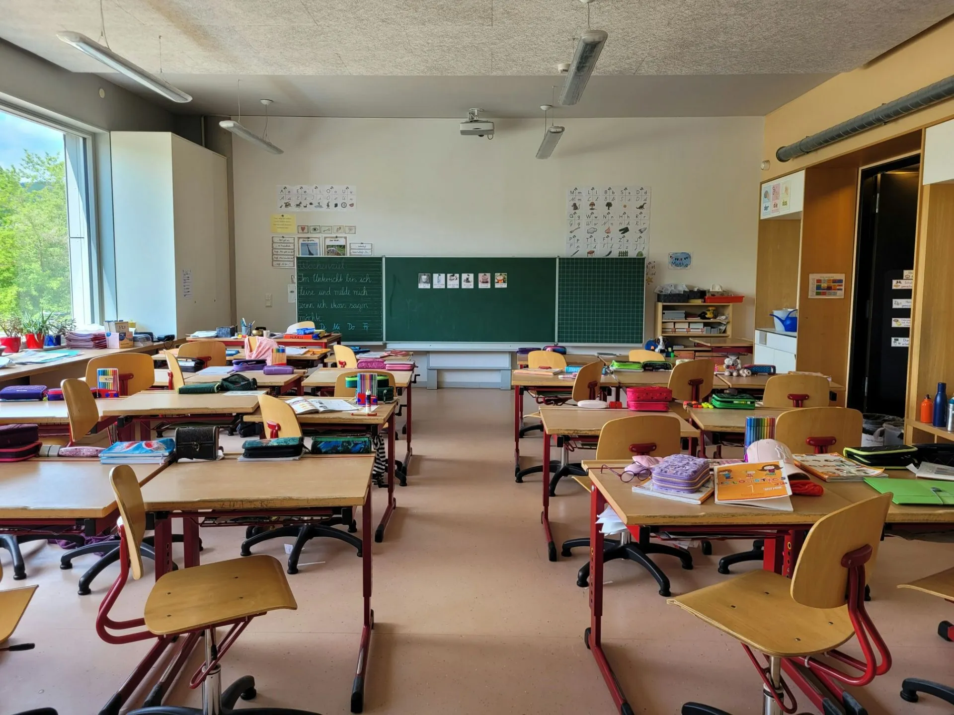 Klassenzimmer mit Tischen und Stühlen, Blick auf die Tafel